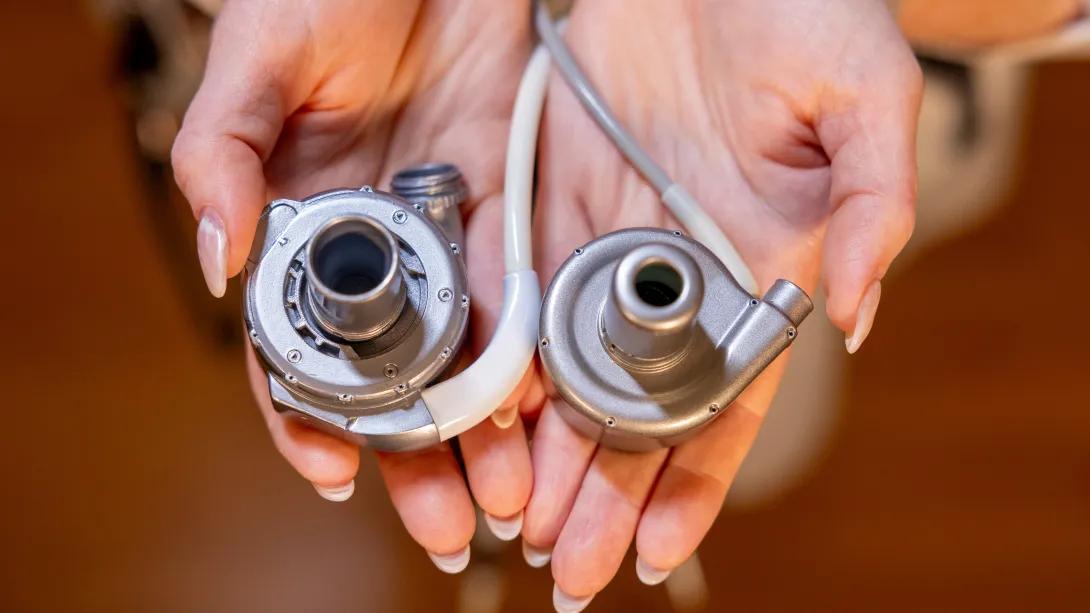 An educator demonstrates the HeartMate 3 Left Ventricular Assist System (left) and BrioVAD System (right).
