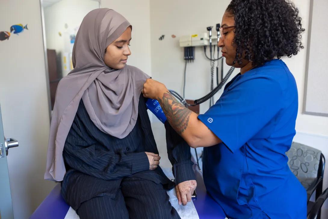 Provider examining a patient in an exam room