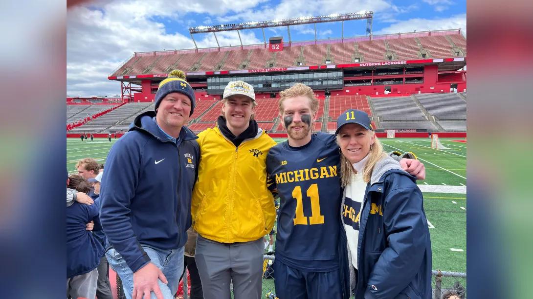 two students in college with their parents in UM field