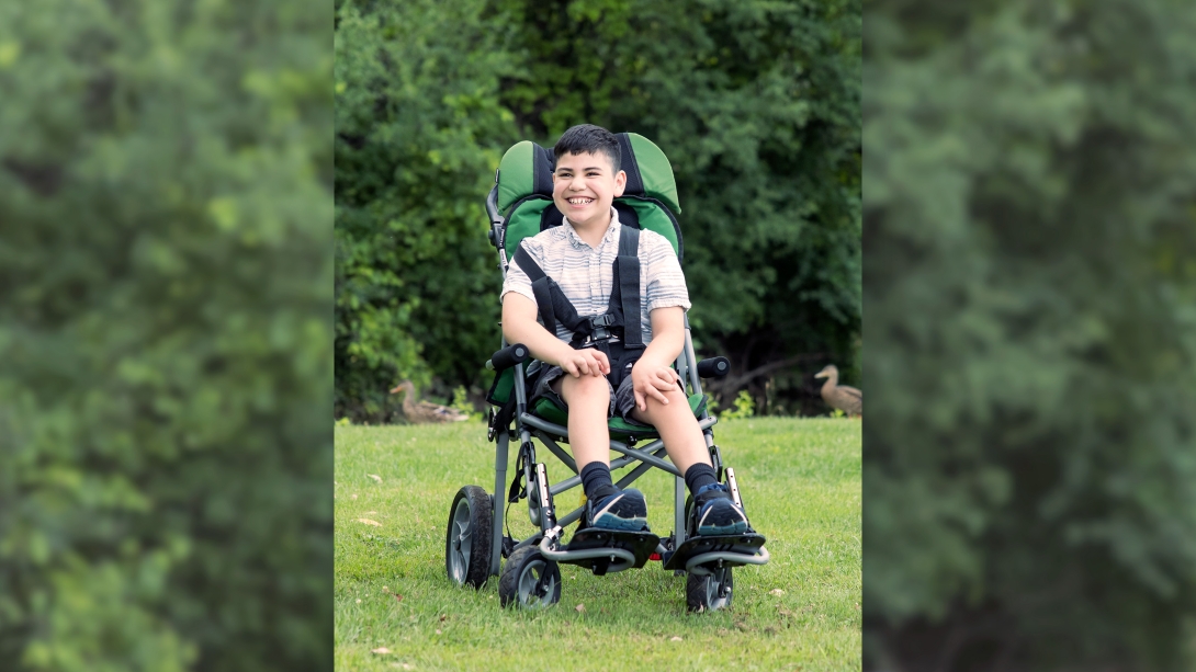 teen in wheelchair seat smiling