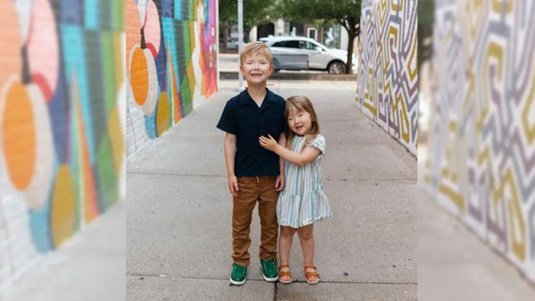 kids hugging down colorful alley way outside