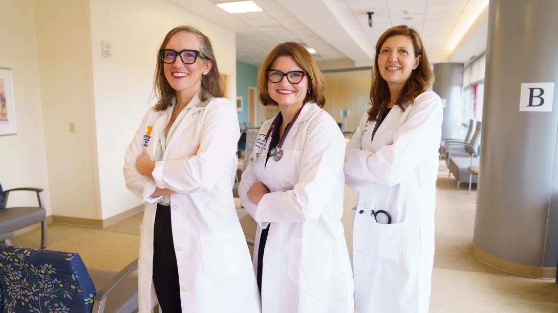three doctors standing posing together