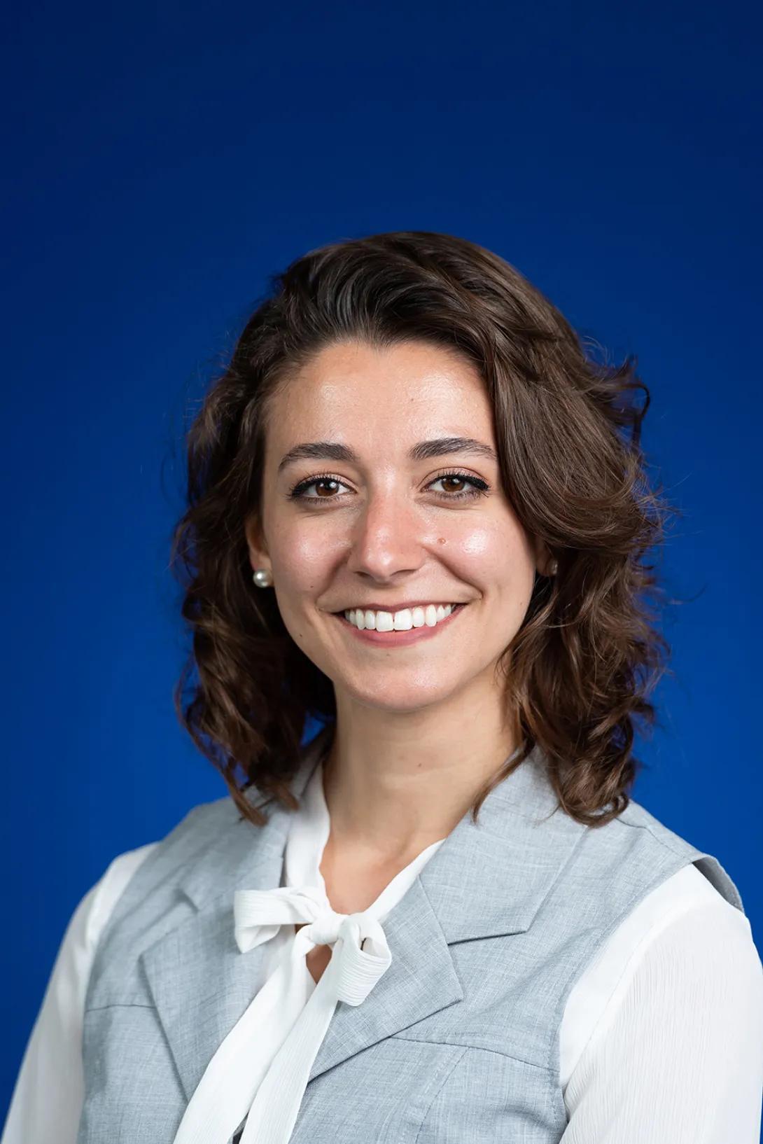 Headshot of Kelly Bertoni. She is wearing a light blue vest and a white blouse.