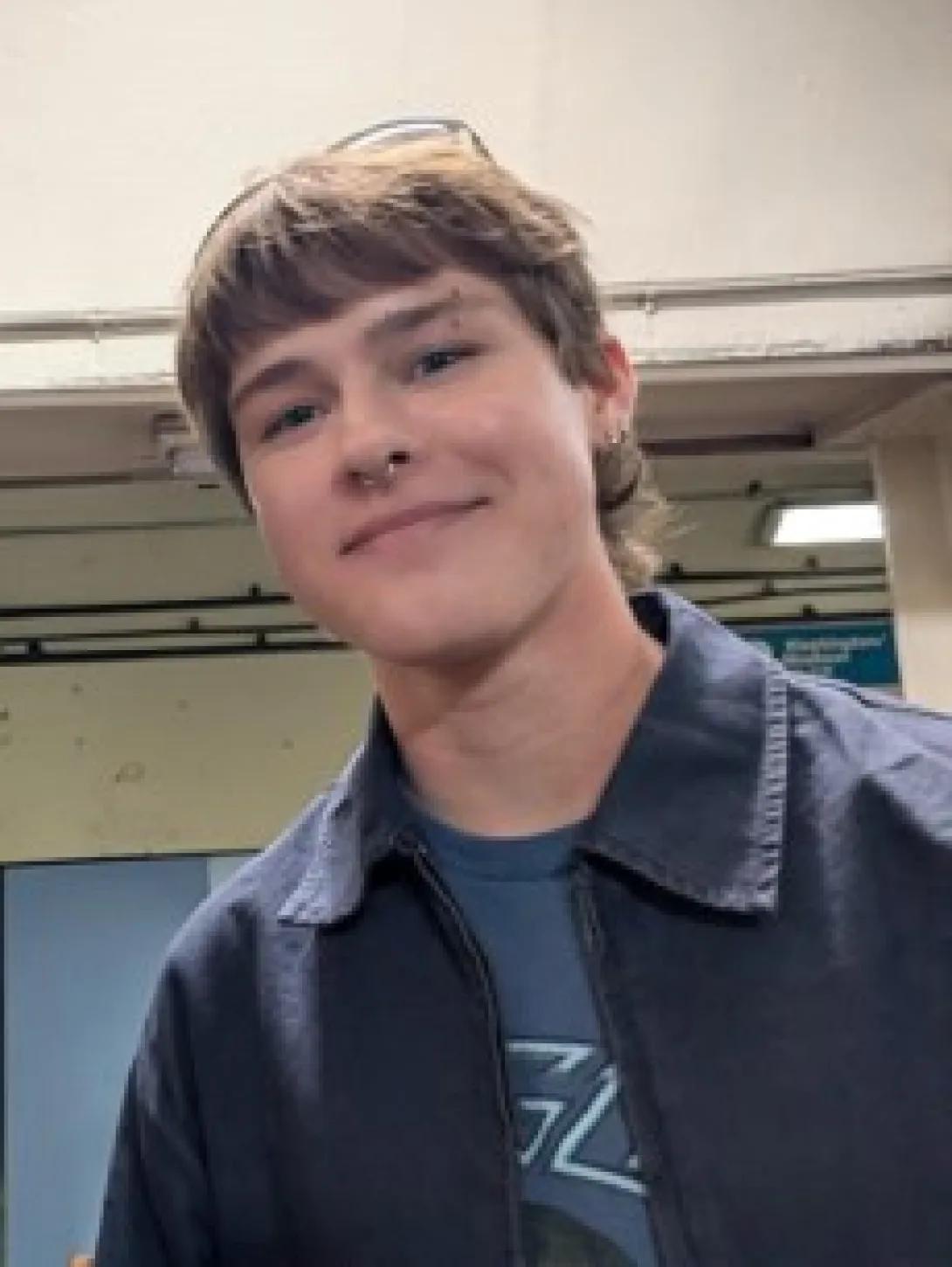 A photo of Eliot Redwine, who describes himself as having dark blond hair, pale skin, and green eyes.