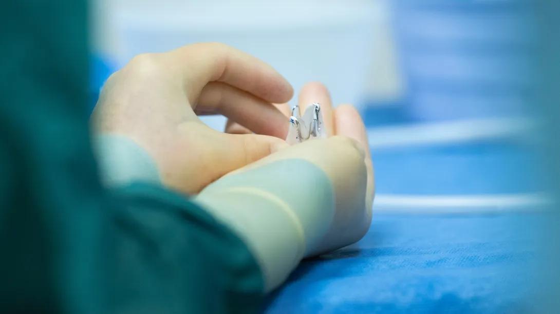 close up in gloved hands of device